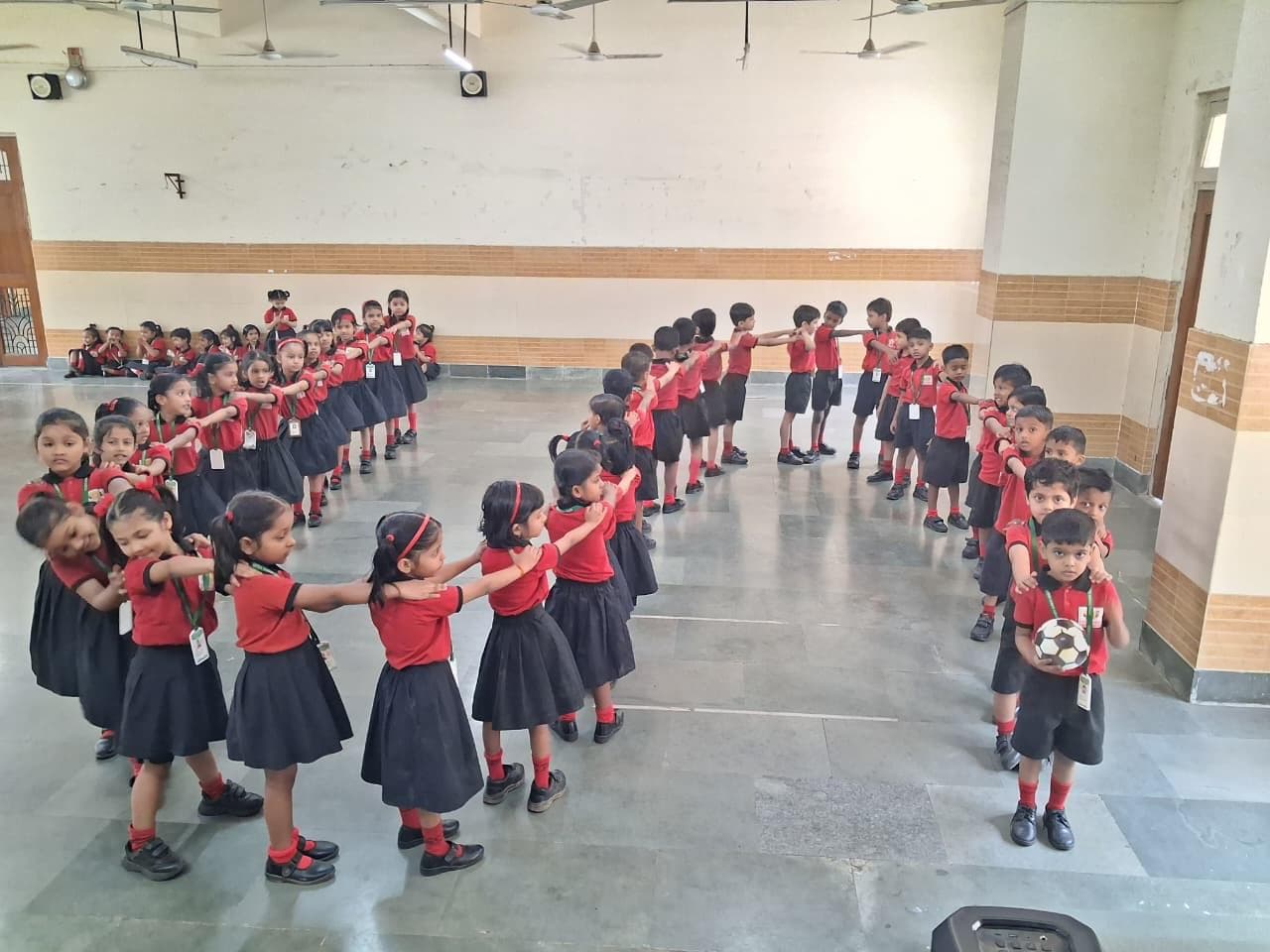 Students standing in a chain formation with hands on each other's shoulders